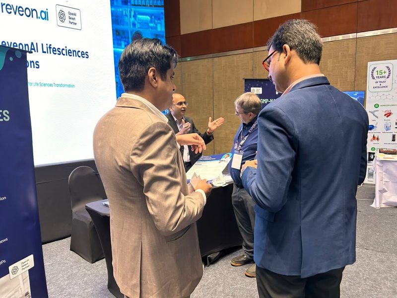 ReveonAI co-founders in conversation with visiting quality and manufacturing professionals at the stand